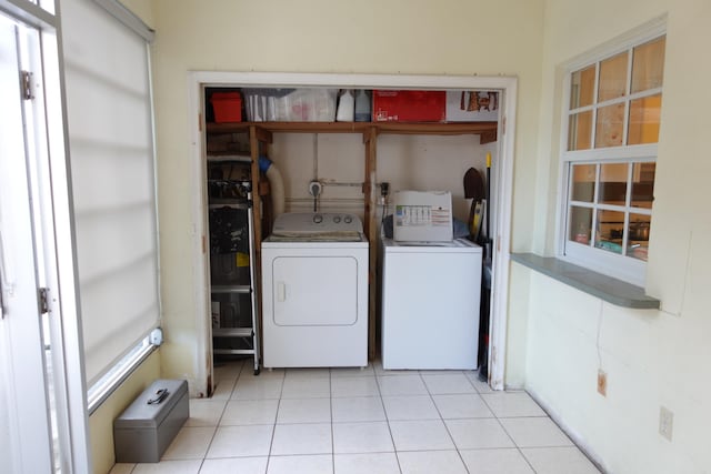 clothes washing area featuring independent washer and dryer and light tile patterned floors