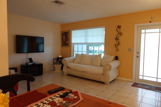 living room with plenty of natural light and light tile patterned floors