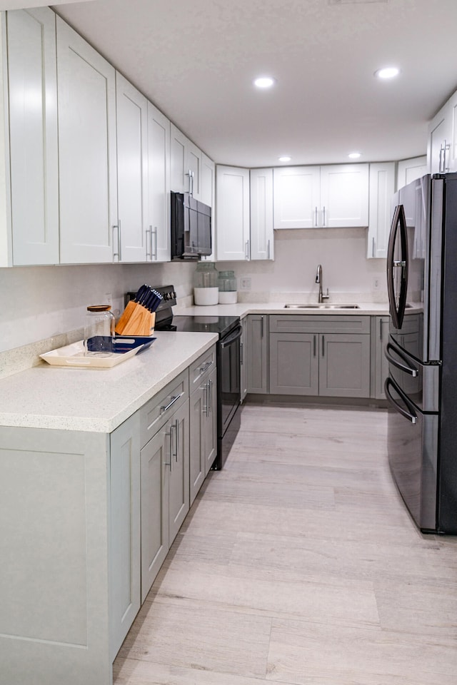 kitchen featuring gray cabinets, sink, and black appliances