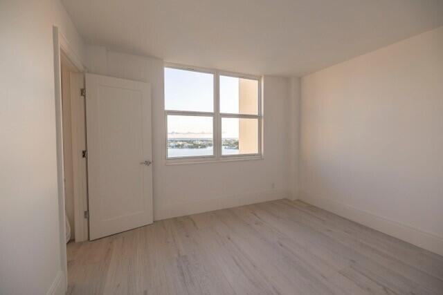 spare room featuring light hardwood / wood-style flooring