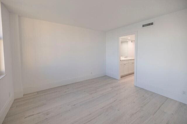 empty room with light hardwood / wood-style flooring