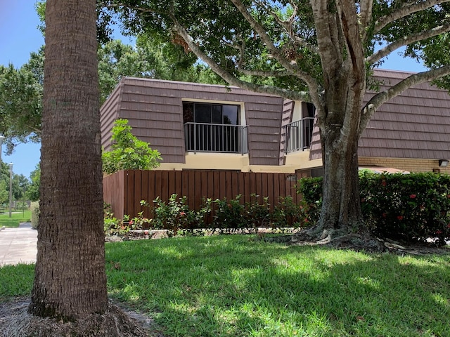 view of side of home with a lawn