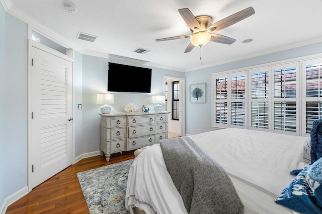 bedroom featuring crown molding, dark hardwood / wood-style flooring, ceiling fan, and a textured ceiling