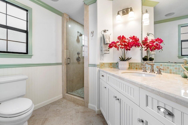 bathroom featuring toilet, an enclosed shower, tile patterned flooring, crown molding, and vanity