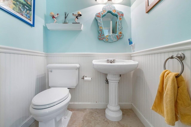 bathroom featuring tile patterned flooring and toilet