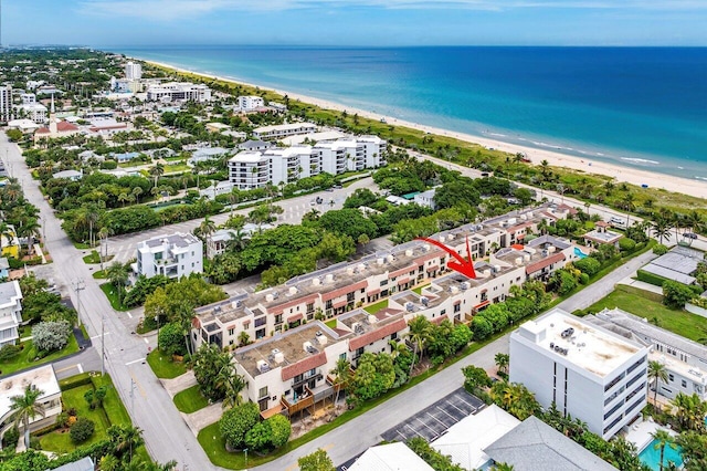 drone / aerial view with a water view and a beach view