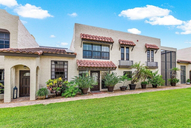 mediterranean / spanish-style home featuring a front lawn