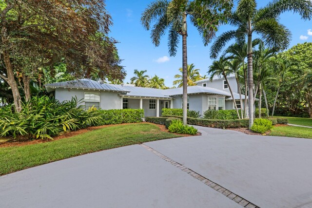920 Hibiscus Ln, Delray Beach, FL 33444 - single story home with driveway, a front lawn, and stucco siding