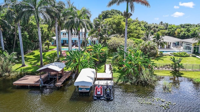 dock area with a lawn and a water view