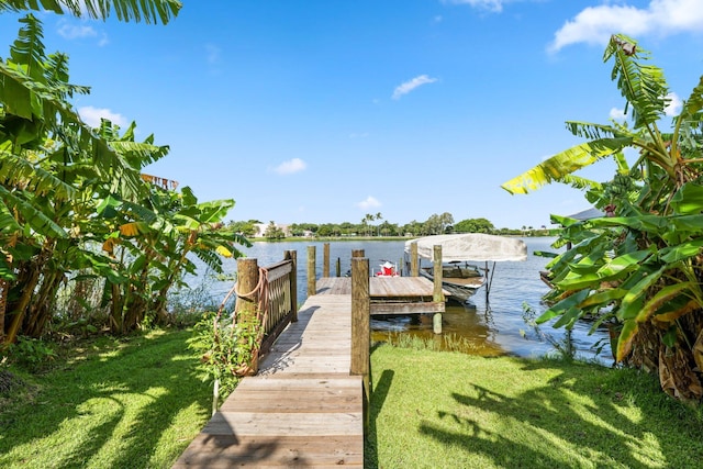 view of dock featuring a yard and a water view