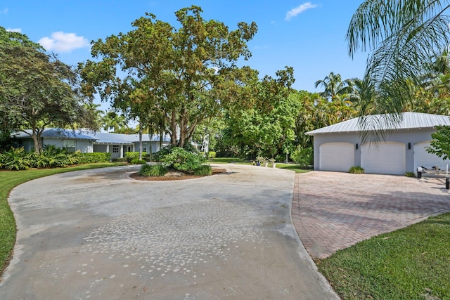 920 Hibiscus Ln, Delray Beach, FL 33444 - view of front of property featuring a detached garage and stucco siding