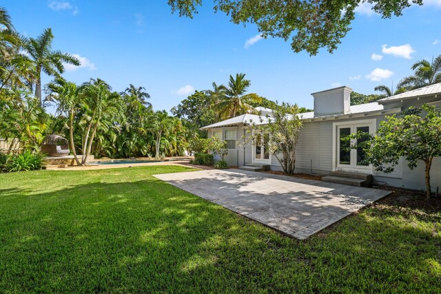 920 Hibiscus Ln, Delray Beach, FL 33444 - view of yard featuring entry steps, a patio, french doors, and an outdoor pool