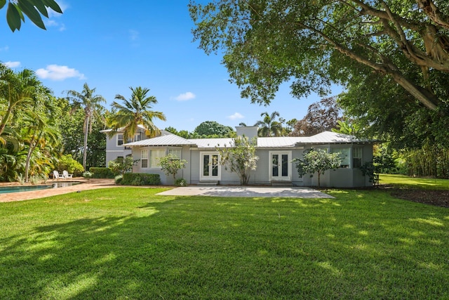 rear view of property with a patio area and a yard