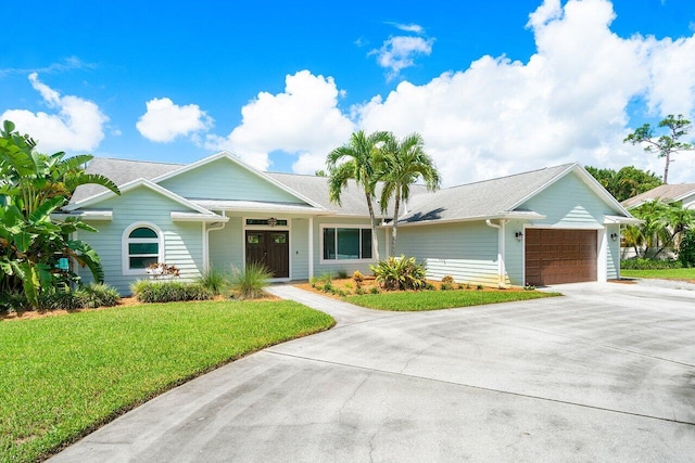 single story home featuring a front lawn and a garage