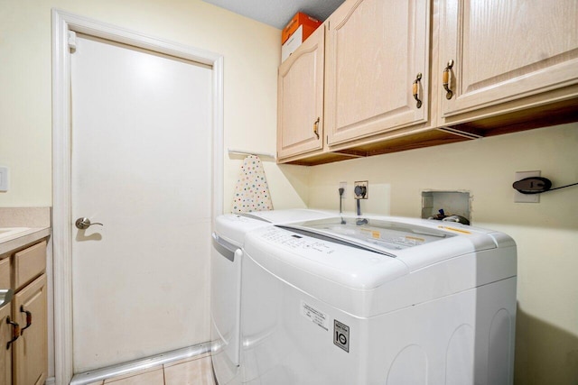 washroom featuring cabinets and separate washer and dryer