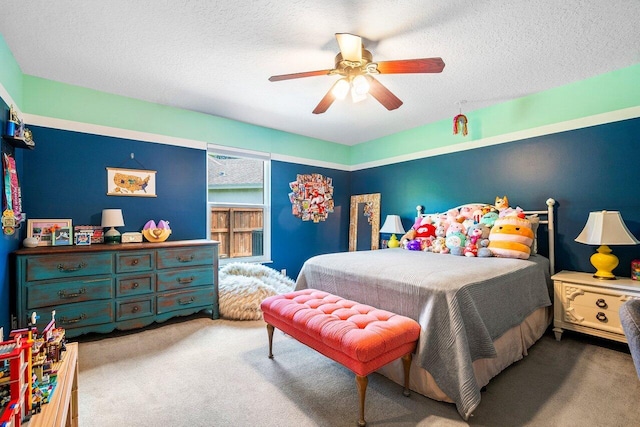 carpeted bedroom with ceiling fan and a textured ceiling