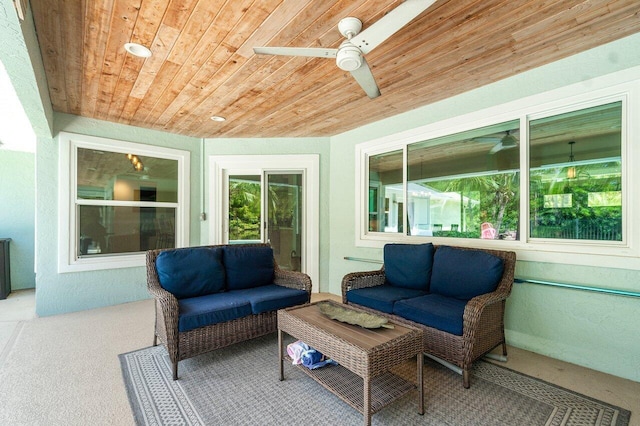 sunroom with wood ceiling and ceiling fan