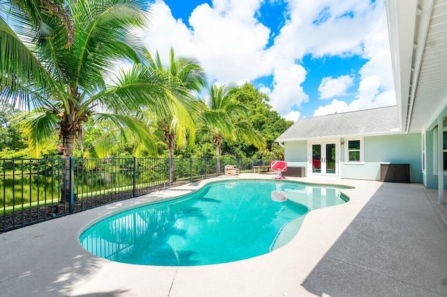 view of swimming pool featuring french doors and a patio