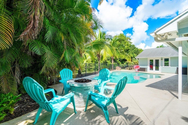 view of swimming pool featuring a fire pit and a patio area