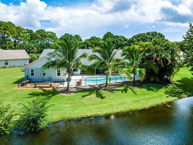 rear view of property featuring a yard and a water view