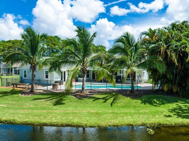 view of property's community featuring a yard, a pool, and a water view