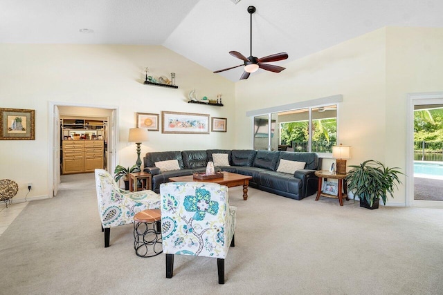 living room featuring ceiling fan, light carpet, and high vaulted ceiling