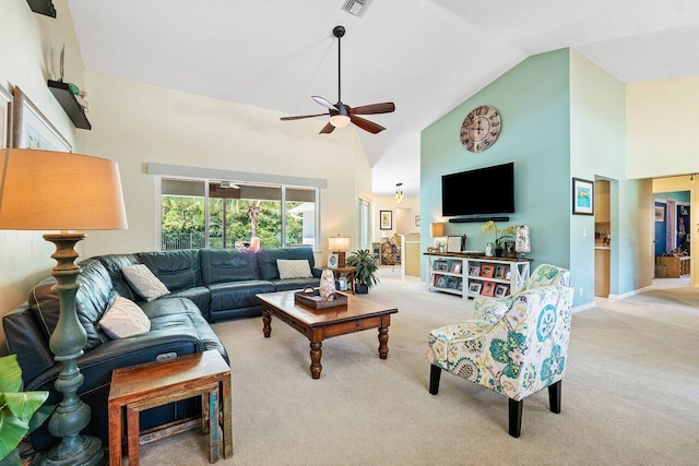 carpeted living room with ceiling fan and high vaulted ceiling