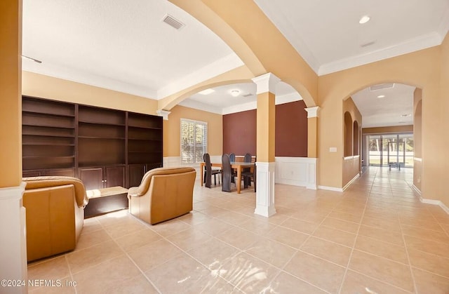 interior space with built in shelves, ornamental molding, and ornate columns