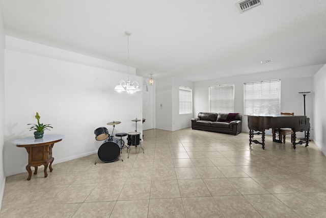 dining space featuring a wealth of natural light, visible vents, a notable chandelier, and light tile patterned flooring