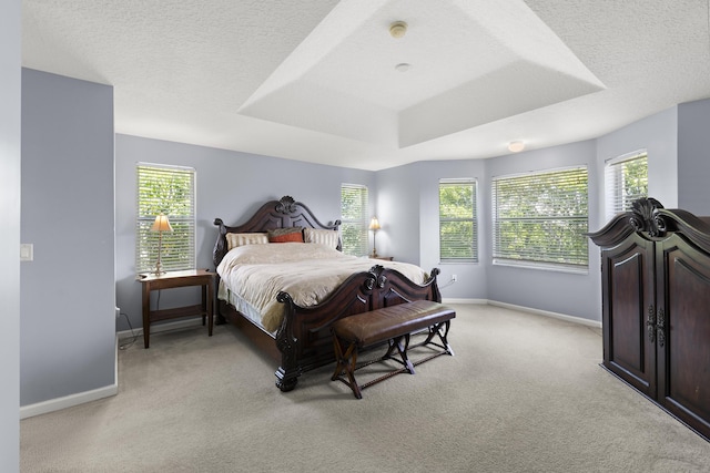 bedroom with light carpet, multiple windows, and baseboards