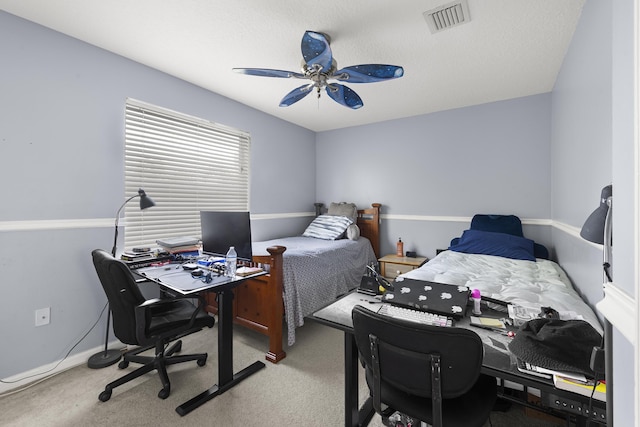 bedroom with ceiling fan, a textured ceiling, visible vents, baseboards, and carpet