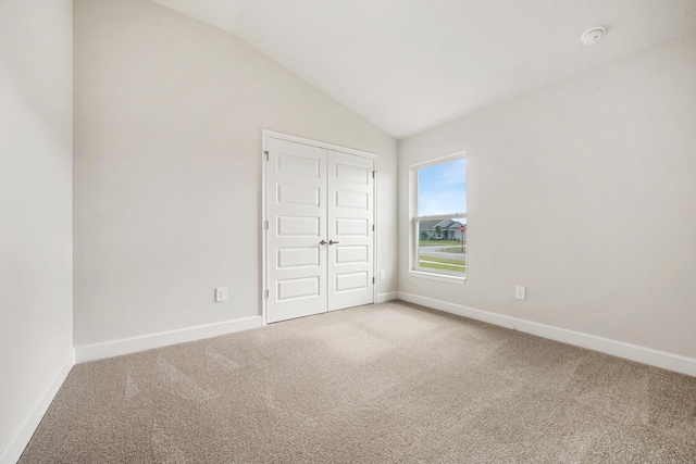 5471 Lugo St, Fort Pierce, FL 34951 - unfurnished bedroom with carpet flooring, vaulted ceiling, baseboards, and a closet