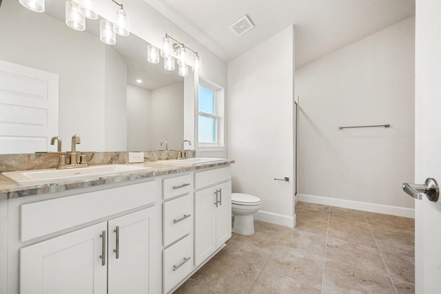5471 Lugo St, Fort Pierce, FL 34951 - bathroom with double vanity, toilet, and baseboards