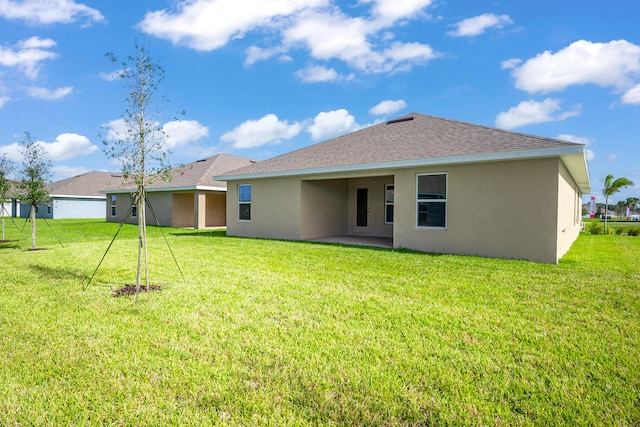 back of house with a yard