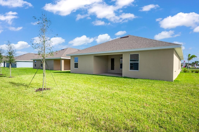 5471 Lugo St, Fort Pierce, FL 34951 - rear view of property with stucco siding, a lawn, and roof with shingles