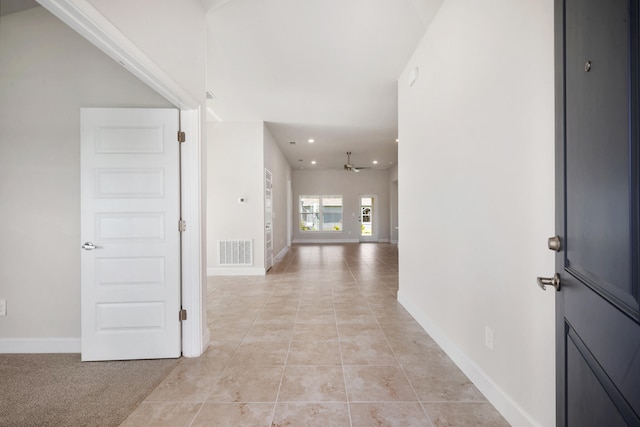 spare room featuring carpet and lofted ceiling