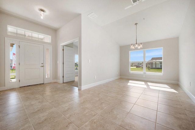 entrance foyer with light tile patterned floors, a chandelier, and lofted ceiling