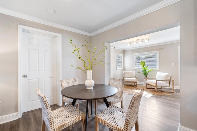 dining space featuring crown molding and dark wood-type flooring