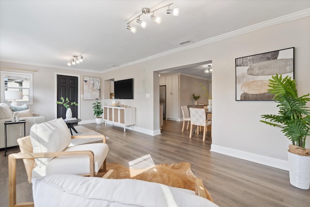 living room featuring ornamental molding and wood-type flooring