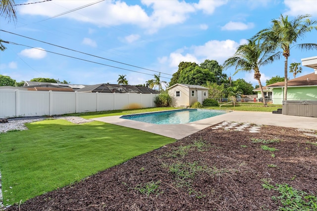 view of pool with a yard, an outdoor structure, and a patio area