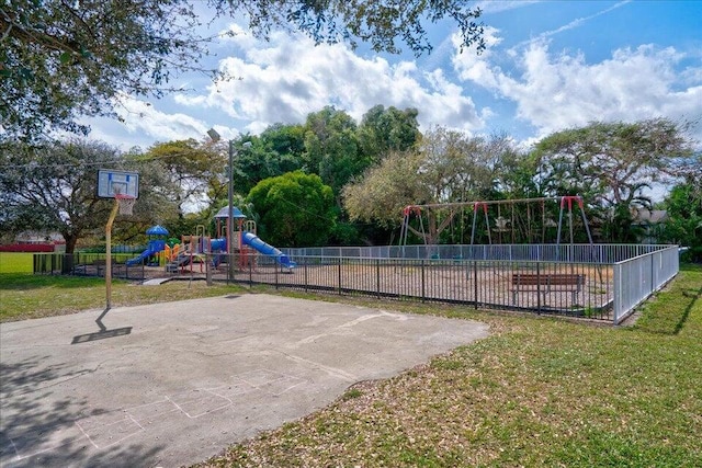 view of jungle gym with a yard and basketball court