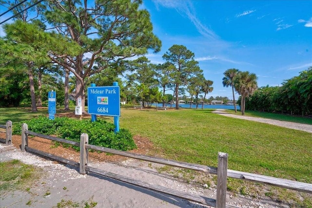 view of community with a water view and a yard