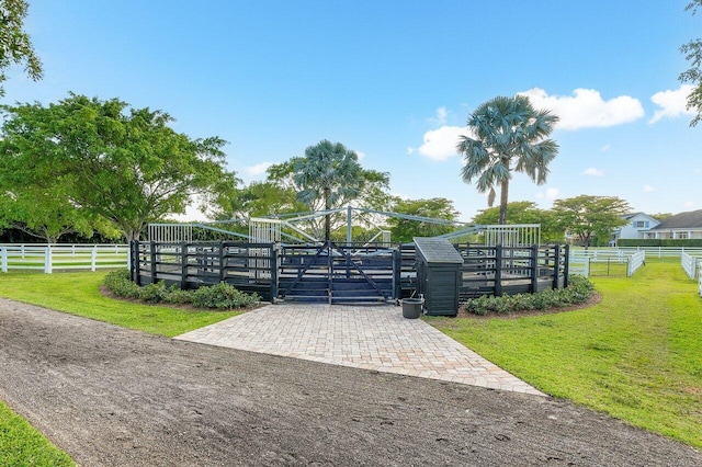 view of gate with a yard