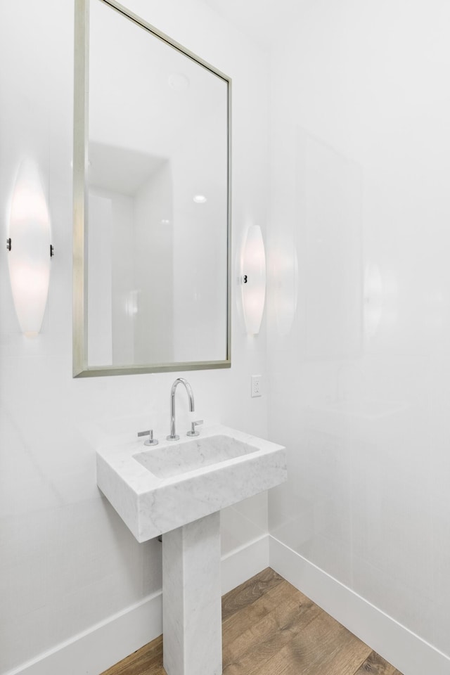 bathroom with hardwood / wood-style floors