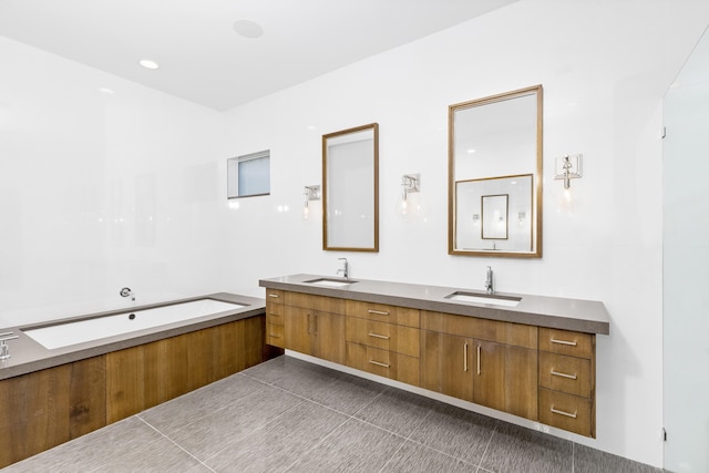 bathroom featuring a bath, tile patterned flooring, and vanity