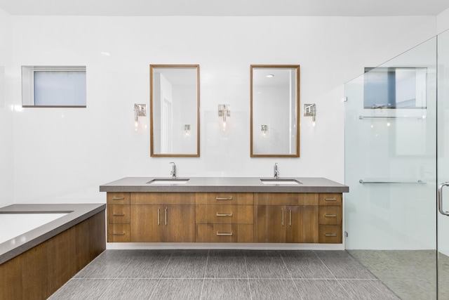 bathroom featuring tile patterned flooring, vanity, and a shower with shower door