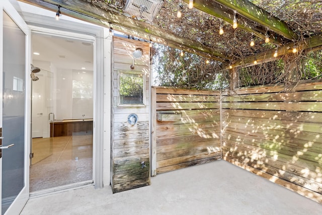 bathroom featuring wood walls and concrete flooring