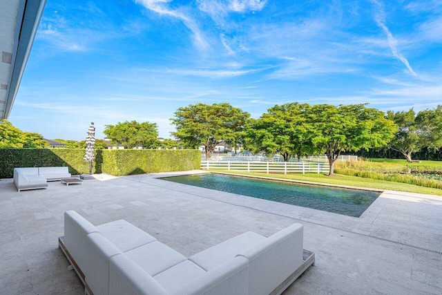 view of swimming pool featuring a lawn and a patio