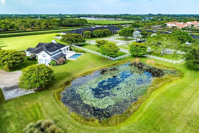 birds eye view of property with a water view and a rural view