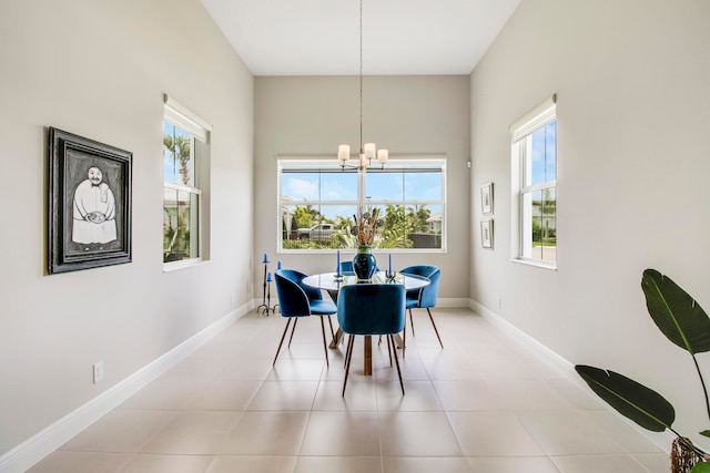 dining area with light tile patterned floors and an inviting chandelier